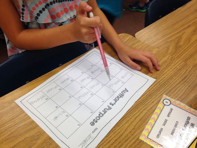 student completing a scoot recording sheet with a pink pencil