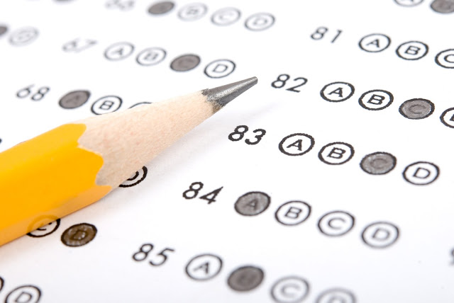multiple choice testing sheet with pencil