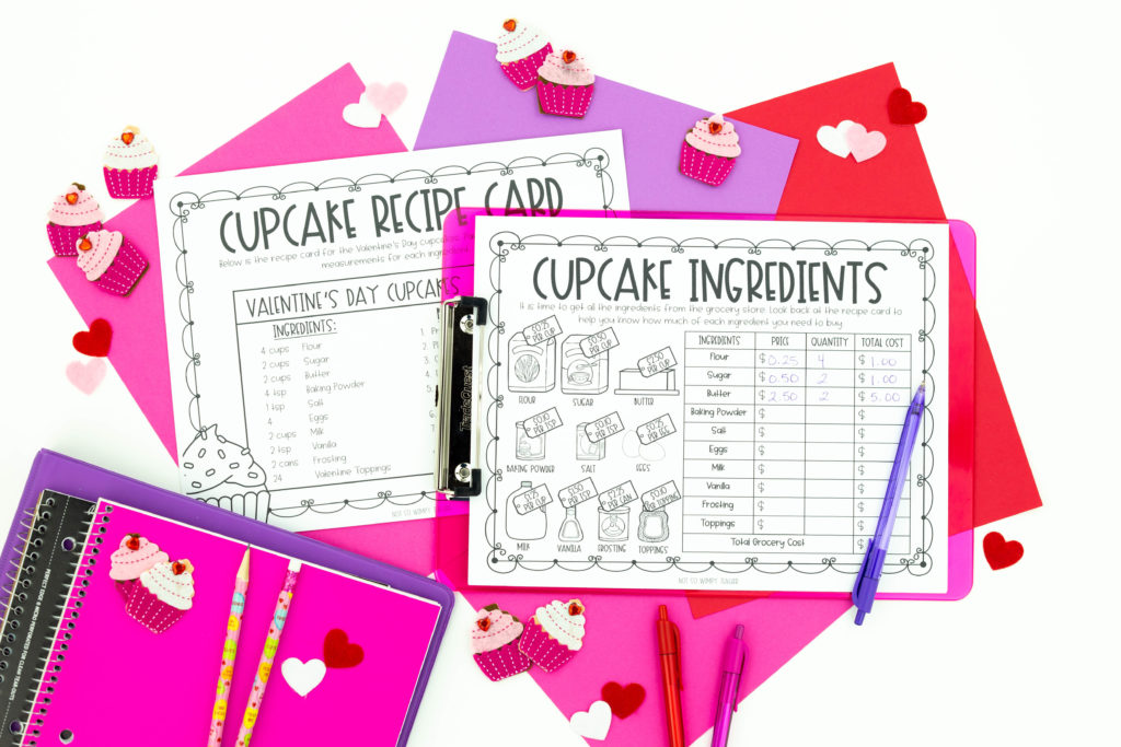 Valentine project used learning pages on clipboards surrounded by pink and purple papers, notebooks and cupcakes